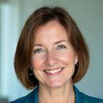 Professional headshot of Anna Miller, a certified health coach with Lumina Wellspring, specializing in stress management and chronic conditions.